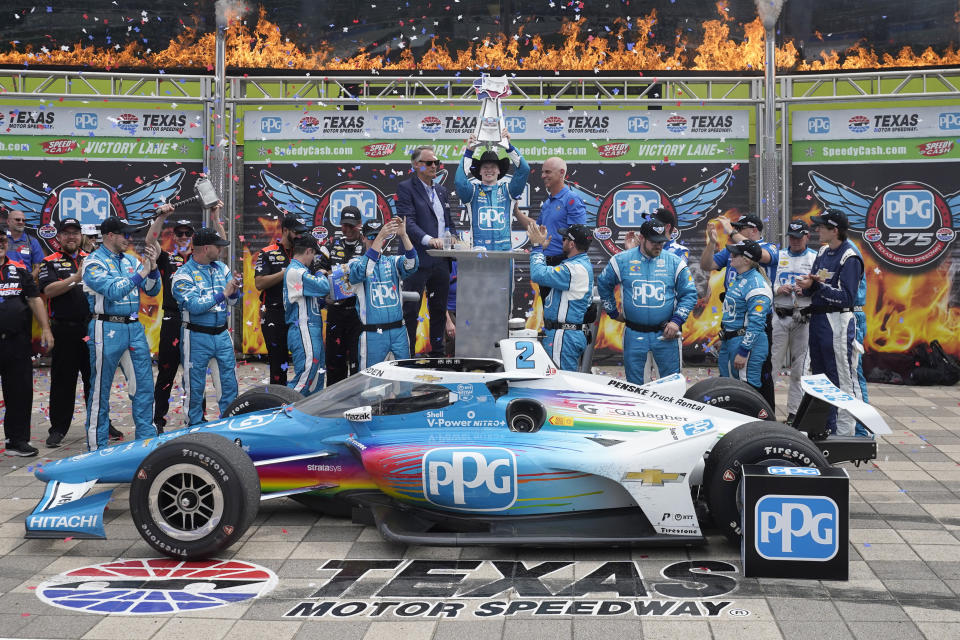 Josef Newgarden, center, celebrates winning the IndyCar auto race at Texas Motor Speedway in Fort Worth, Texas, Sunday, April 2, 2023. (AP Photo/LM Otero)