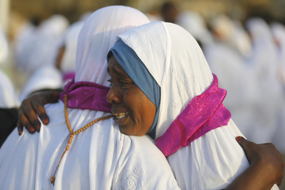 Sudanese pilgrims embrace as they congratulate each other for performing the the annual hajj pilgrimage near the Mountain of Mercy, on the Plain of Arafat, near the holy city of Mecca, Saudi Arabia, Saturday, Aug. 10, 2019. More than 2 million pilgrims were gathered to perform initial rites of the hajj, an Islamic pilgrimage that takes the faithful along a path traversed by the Prophet Muhammad some 1,400 years ago. (AP Photo/Amr Nabil)