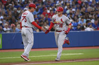St. Louis Cardinals' Nolan Gorman, right, celebrates with third base coach Ron "Pop" Warner (75) after hitting a solo home run against the Toronto Blue Jays during the fifth inning of a baseball game Wednesday, July 27, 2022, in Toronto. (Jon Blacker/The Canadian Press via AP)