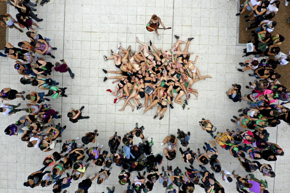 Women perform near the Congress during a march to commemorate the International Women's Day in Buenos Aires, Argentina, Monday, March 9, 2020. (AP Photo/Julian Bongiovanni)