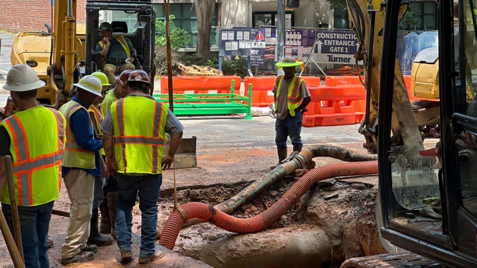 Workers try to fix a leaking water main junction on Monday in Atlanta. - Jeff Amy/AP