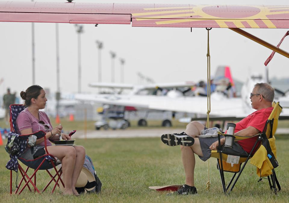 Ken Summers and Alexis Bachicha sit in the shade of their aircraft during EAA AirVenture Oshkosh 2023 on Monday, July 24, 2023 in Oshkosh, Wis. Wm. Glasheen USA TODAY NETWORK-Wisconsin