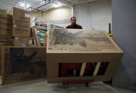 Lowe's employee Justin Sanderson takes an unassembled snow blower out to the selling floor at the Lowe's store in Kentlands, Maryland January 21, 2016. REUTERS/Gary Cameron