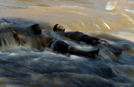 Residents are seen on Paraopeba River after a tailings dam owned by Brazilian mining company Vale SA collapsed, in Curvelo near Brumadinho, Brazil Februarary 11, 2019. REUTERS/Washington Alves