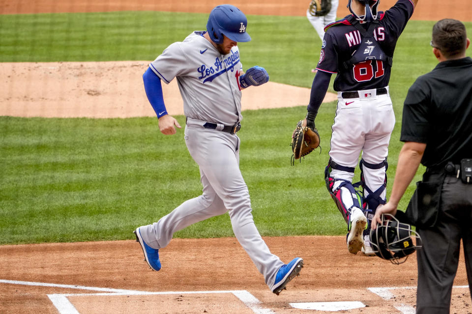 Los Angeles Dodgers' Max Muncy scores on a single by Jason Heyward during the first inning of a baseball game against the Washington Nationals at Nationals Park, Sunday, Sept. 10, 2023, in Washington. (AP Photo/Andrew Harnik)