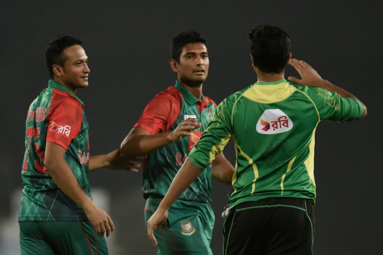 Bangladesh's Mohammad Mahmudullah (C) and Shakib Al Hasan (R) celebrate after winning their Asia Cup Twenty20 match against Pakistan, at the Sher-e-Bangla National Cricket Stadium in Dhaka, on March 2, 2016
