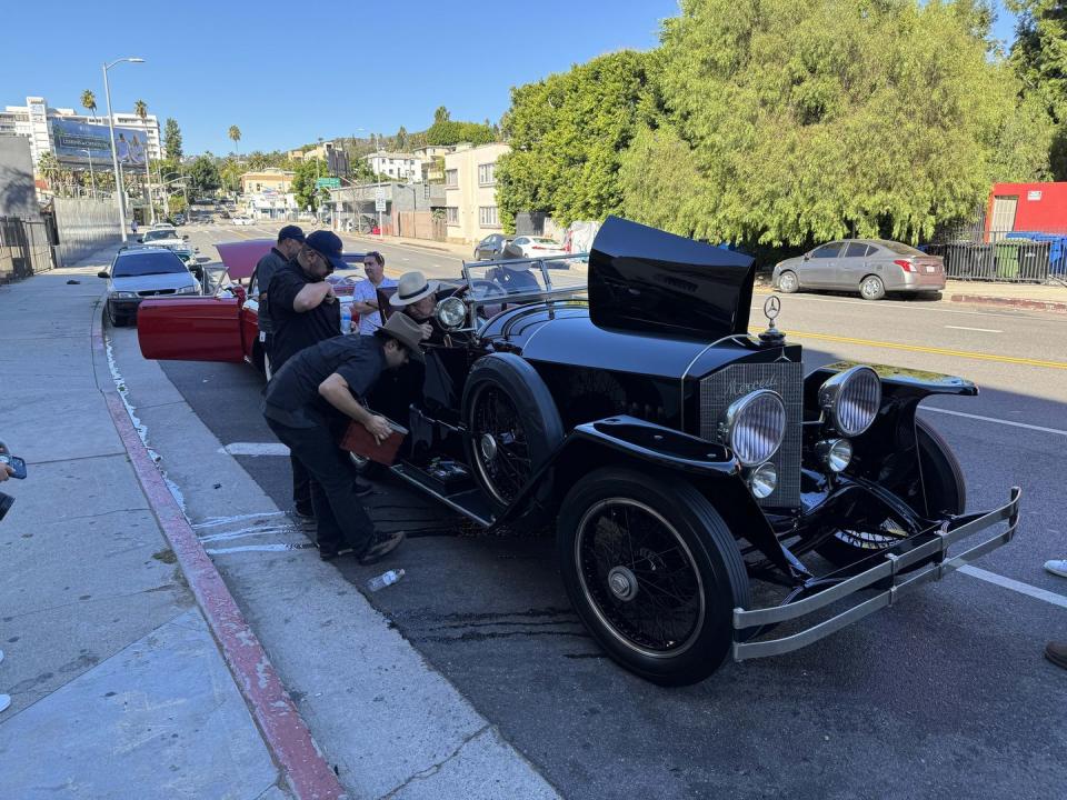 a group of people working on a car