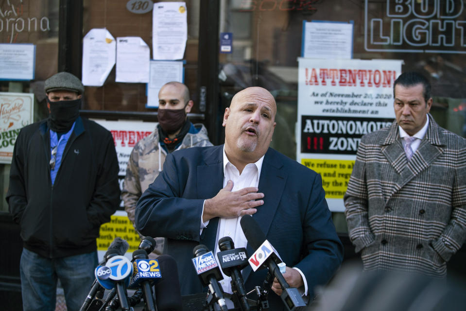 Attorney Louis Gelormino speaks outside Mac's Public House during a press conference outside the closed bar on Staten Island Monday, Dec. 7, 2020, in New York. Authorities in New York City said Danny Presti, the co-owner of the bar that was defying coronavirus restrictions, was arrested early Sunday, Dec. 6 after running over a deputy with his car. (AP Photo/Eduardo Munoz Alvarez)