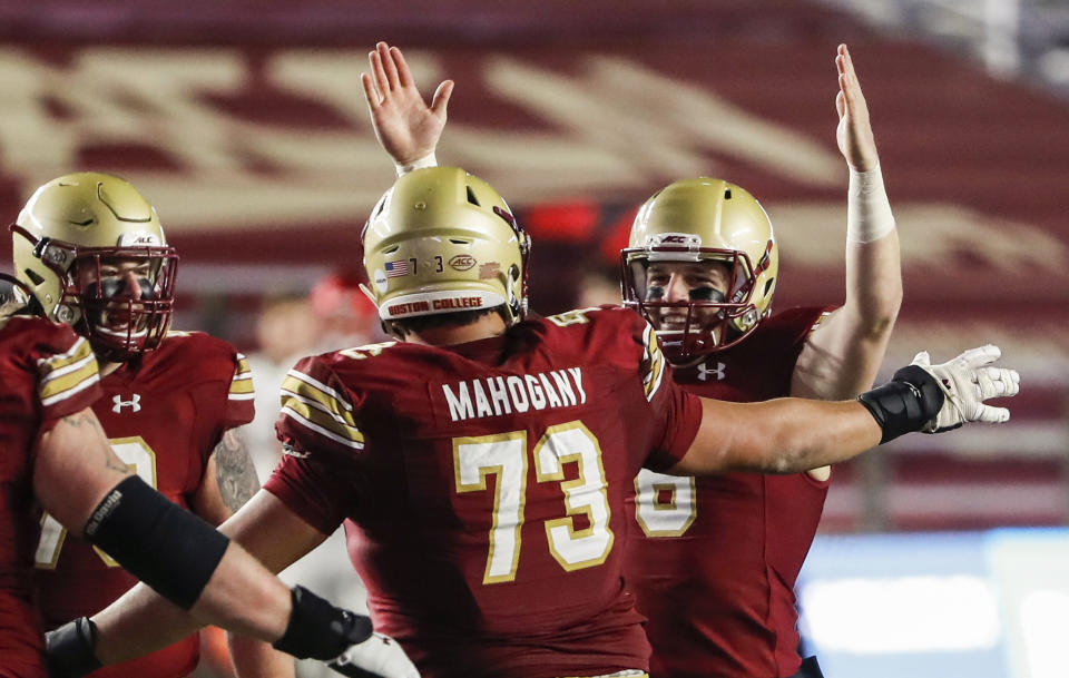 Nov 28, 2020; Chestnut Hill, Massachusetts, USA; Boston College Eagles quarterback Dennis Grosel (6) celebrates a touchdown pass with offensive lineman Christian Mahogany (73) against the Louisville Cardinals during the second half at Alumni Stadium. Mandatory Credit: Winslow Townson-USA TODAY Sports