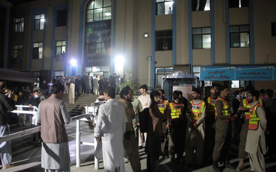 Rescue workers and people gather at a hospital in Saidu Sharif - AP