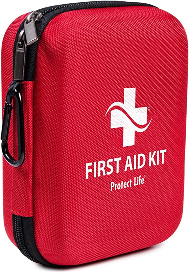 Red First-Aid kit that includes gloves, bandages, scissors, etc.