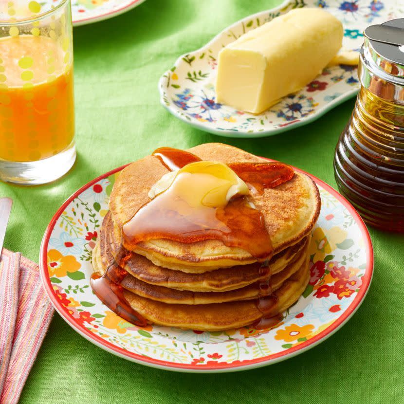 easter brunch ideas edna maes sour cream pancakes stacked on floral plate with butter stick