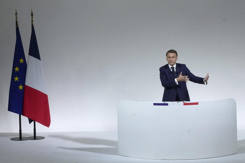 French President Emmanuel Macron answers questions after delivering a speech, Wednesday, June 12, 2024 in Paris. French President Emmanuel Macron called for moderate politicians from the left and the right to regroup to defeat the far-right in general elections. (AP Photo/Michel Euler)