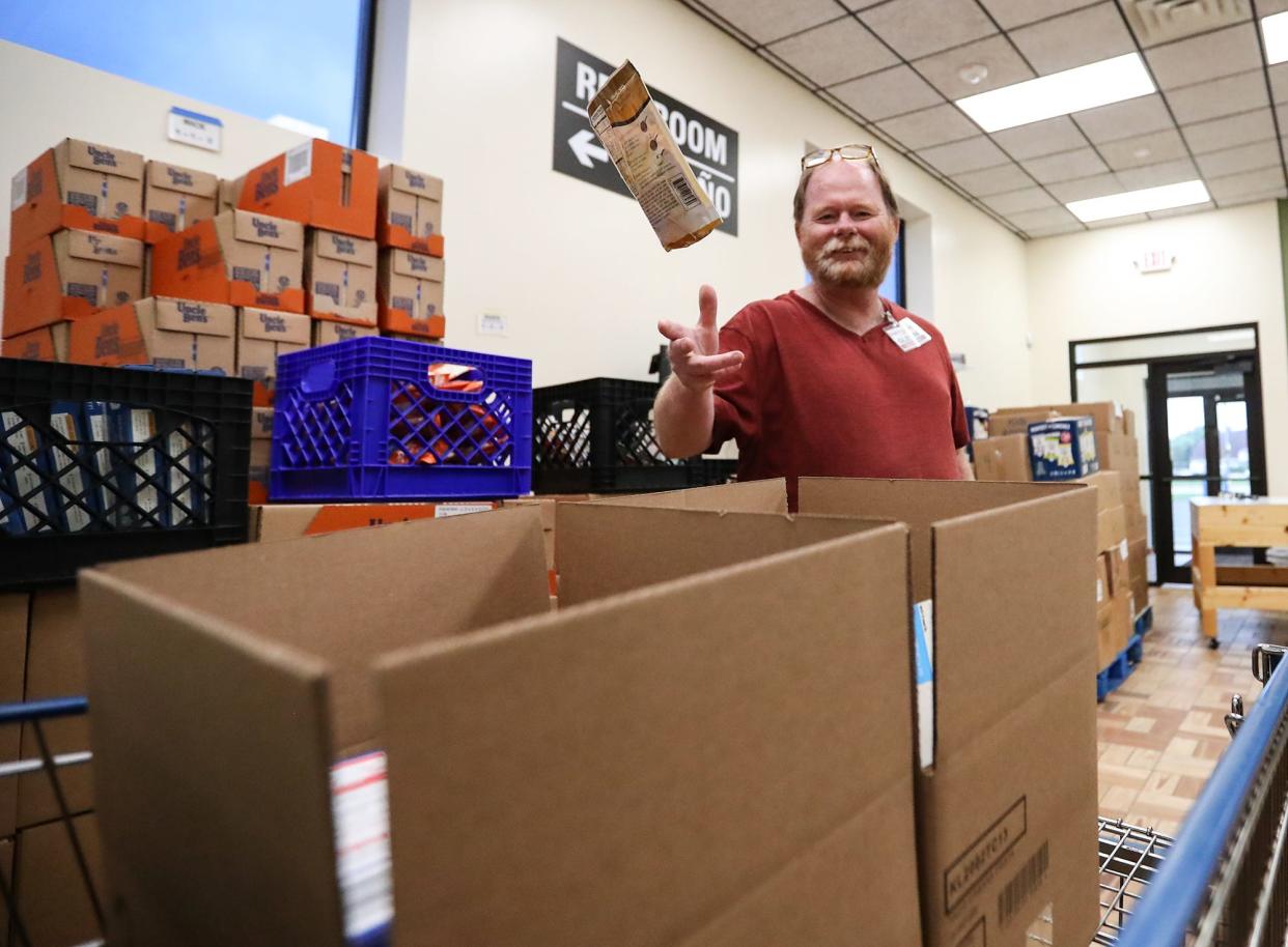 Pantry volunteer Glenn Bulman packs dry goods into boxes at the Fondy Food Pantry in Fond du Lac.