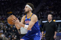 Milwaukee Bucks head coach Mike Budenholzer, right, watches as Golden State Warriors guard Klay Thompson prepares to shoot a 3-point basket during the first half of an NBA basketball game in San Francisco, Saturday, March 12, 2022. (AP Photo/Jeff Chiu)