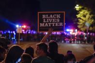 Protesters and police line up Friday, Oct. 9, 2020, in Wauwatosa, Wis. On Wednesday, District Attorney John Chisholm refused to issue charges against Wauwatosa Police Officer Joseph Mensah for the Feb. 2 fatal shooting of 17-year-old Alvin Cole at Mayfair Mall. (AP Photo/Morry Gash)