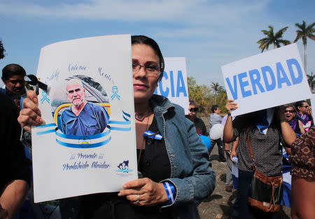 A demonstrator holds a photo of U.S. citizen Eddy Montes who was killed in a prison shooting, during a protest against Nicaraguan President Daniel Ortega's government at the Metropolitan Cathedral in Managua, Nicaragua May 17,2019. REUTERS/Oswaldo Rivas