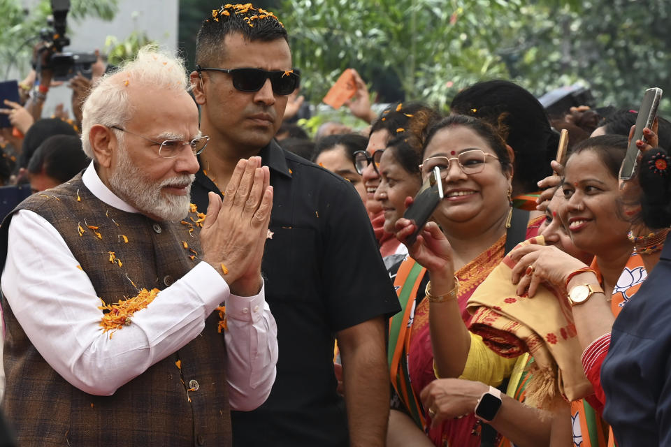 Indian Prime Minister Narendra Modi is welcomed at the Bharatiya Janata Party headquarters, where he was felicitated a day after the women's reservation bill was passed by the Indian Parliament in New Delhi, Friday, Sep. 22, 2023. (AP Photo/STR)