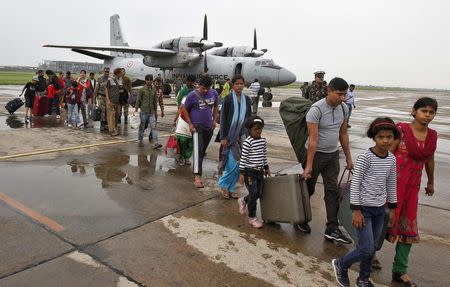 Flood victims arrive at the air force station after being rescued by the Indian armed forces from the flooded areas of Srinagar, in Chandigarh September 12, 2014. REUTERS/Ajay Verma