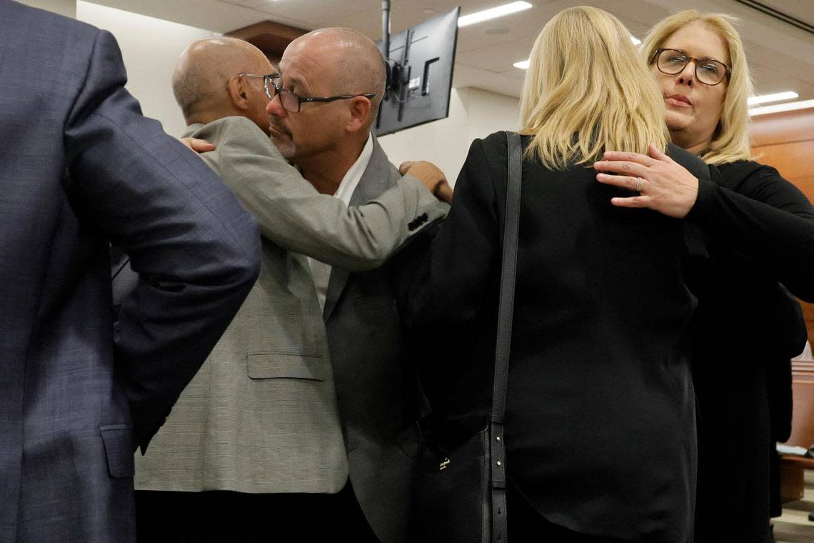 Fred and Jennifer Guttenberg embrace Mitch and Annika Dworet during a break in the sentencing hearing for Marjory Stoneman Douglas High School shooter Nikolas Cruz at the Broward County Courthouse in Fort Lauderdale on Tuesday, Nov. 2, 2022. The Guttenbergs’ daughter, Jaime, and the Dworets’ son Nicholas were killed, and the Dworets’ other son, Alexander, was injured in the 2018 shootings.