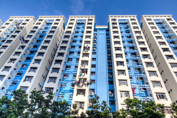 A HDB block with a white and light blue facade