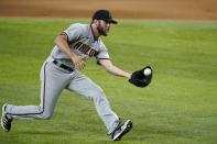 Arizona Diamondbacks relief pitcher Matt Peacock fields a grounder by Texas Rangers' David Dahl, who was out at first during the seventh inning of a baseball game in Arlington, Texas, Tuesday, July 27, 2021. (AP Photo/Tony Gutierrez)