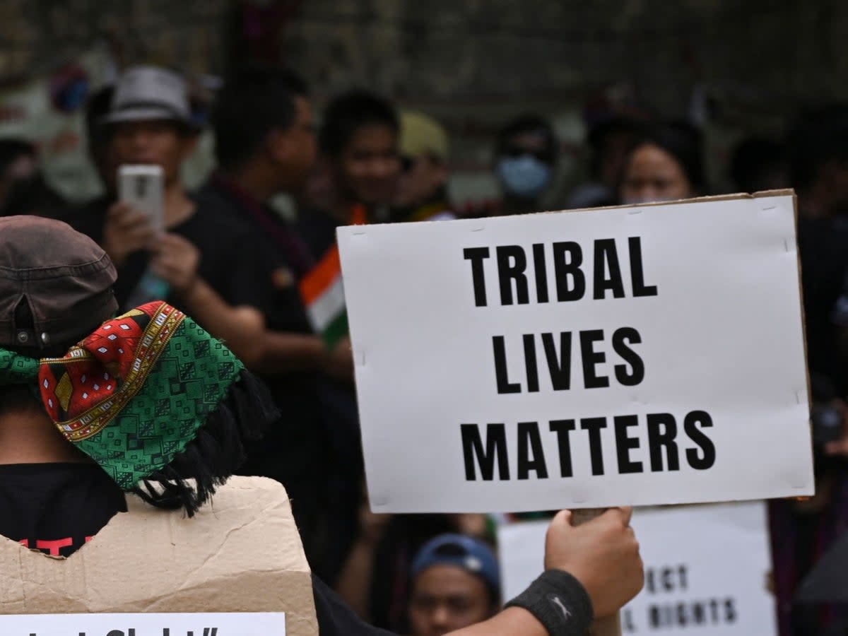 Activists of the All Tribal Students Union Manipur (ATSUM) hold placards during a protest in New Delhi on 31 May 2023 (AFP via Getty Images)