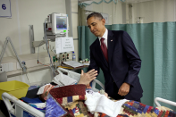 <b>May 1, 2012:</b> "For the President, this was one of the most poignant moments of the his first term. He was visiting wounded warriors in the intensive care unit at Bagram Air Field in Afghanistan. He had just presented a Purple Heart to Sgt. Chase Haag, who had been injured by an IED just hours before. Sgt. Haag was covered with a blanket and it was difficult to see how badly he was injured. He was also seemingly unconscious, or perhaps just asleep. The President whispered in his ear so not to wake him. Just then, there was a rustling under the blanket and Sgt. Haag, eyes still closed, reached his hand out to shake hands with the President. 'I'll never forget that moment,' someone else in the room later told me." (Official White House Photo by Pete Souza)