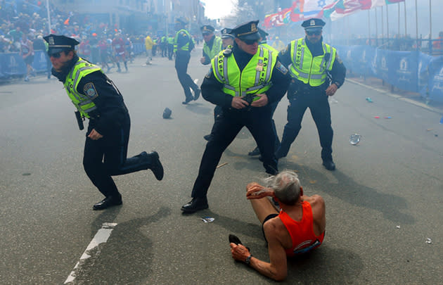 Boston police officers react to the Marathon bombings (John Tlumacki / AP)