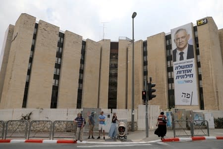 Blue and White party leader Benny Gantz is depicting on his party election campaign banner in Jerusalem