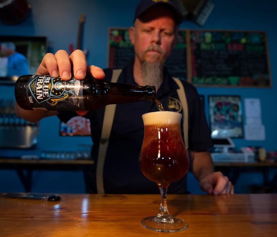 Blue Earl Brewing Co. founder Ronnie Price pours a beer at his Smyrna brewery in 2018.