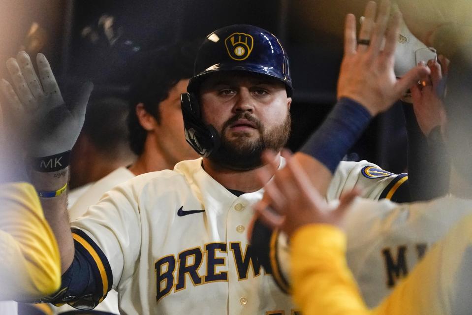 Milwaukee Brewers' Rowdy Tellez is congratulated after hitting a home run during the sixth inning of a baseball game against the St. Louis Cardinals Tuesday, Sept. 27, 2022, in Milwaukee. (AP Photo/Morry Gash)