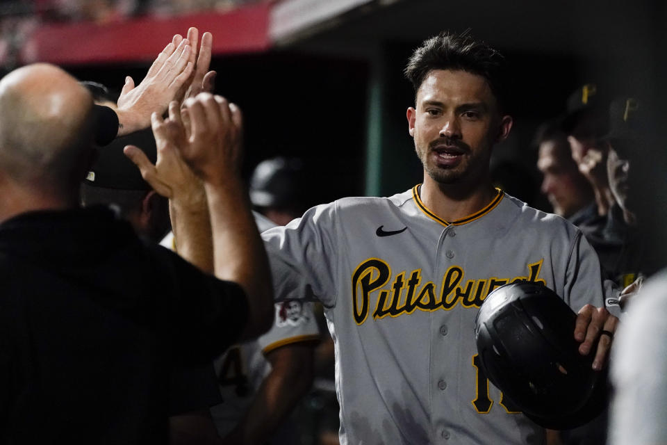 Pittsburgh Pirates' Bryan Reynolds celebrates with teammates after scoring from third base following a throwing error on an attempted double play from Cincinnati Reds shortstop Elly De La Cruz during the seventh inning of a baseball game, Friday, Sept. 22, 2023, in Cincinnati. (AP Photo/Joshua A. Bickel)