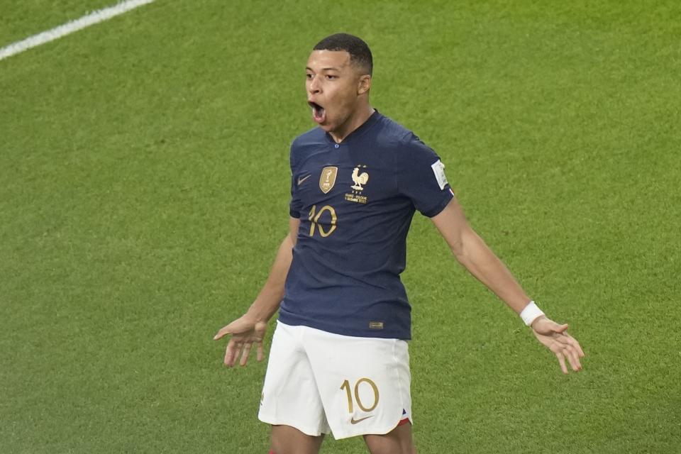 France&#39;s Kylian Mbappe, left, celebrates after scoring the third goal for his side during the World Cup round of 16 soccer match between France and Poland, at the Al Thumama Stadium in Doha, Qatar, Sunday, Dec. 4, 2022. (AP Photo/Luca Bruno)