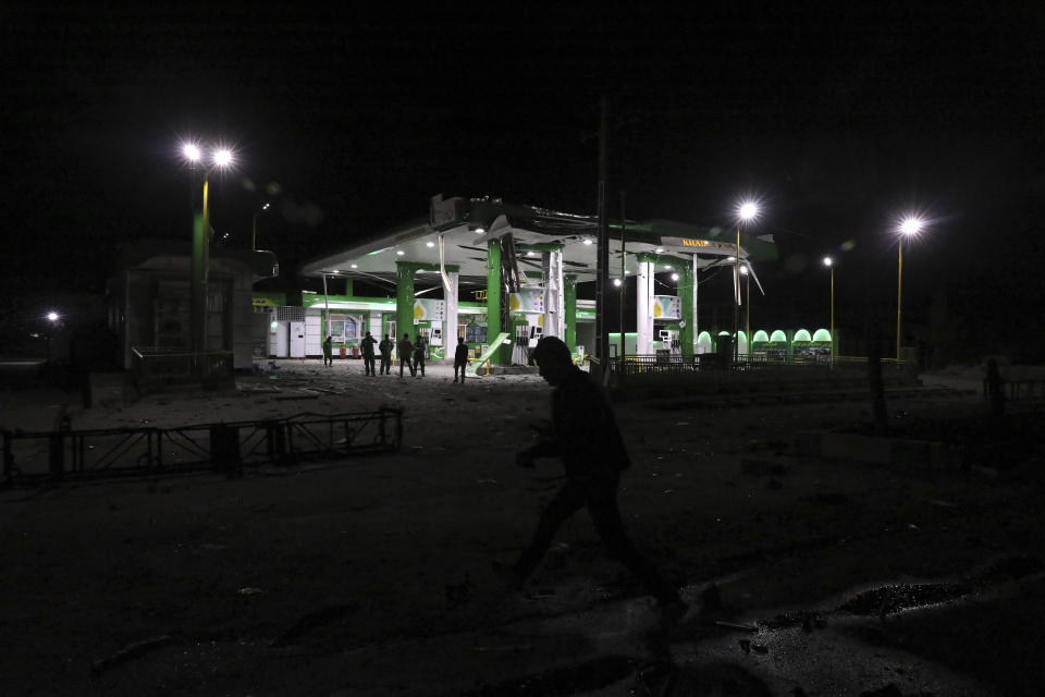 An Afghan man walks at the site of a bombing attack in Kabul, Afghanistan, Wednesday, April 21, 2021. An explosion in the Afghan capital Wednesday wounded at least five people, said an Afghan interior ministry official. (AP Photo/Rahmat Gul)