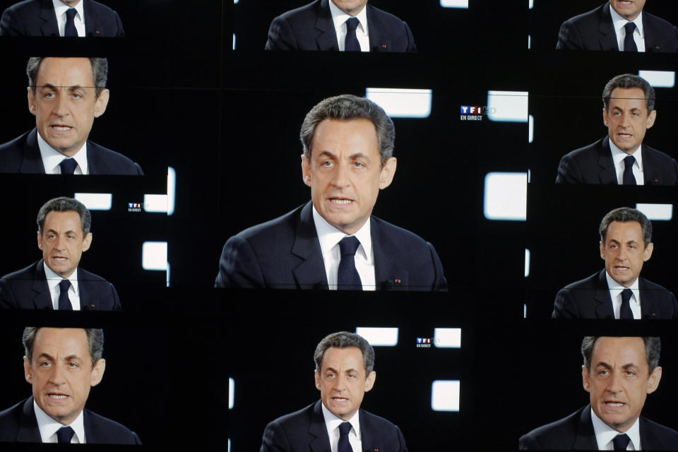 FILE - In this May 2, 2012 file photo, French President and conservative candidate for re-election, Nicolas Sarkozy, is seen on a wall screen during the televised debate with Socialist Party rival Francois Hollande, at the TF1 television studio, in Boulogne-Billancourt, outside Paris. French prosecutors are seeking to send former President Nicolas Sarkozy to trial on charges that he received millions in illegal campaign financing from the regime of late Libyan leader Moammar Gadhafi. (AP Photo/Thibault Camus, File)
