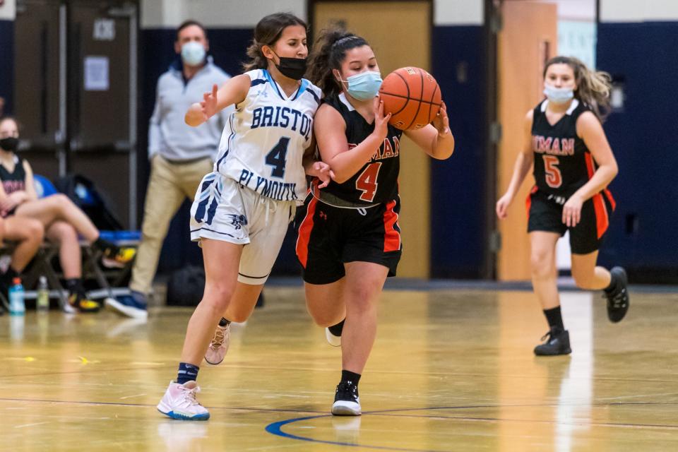 Diman’s Hannah Martin, right, draws contact from Bristol-Plymouth’s Megan Faria in an earlier game this year.