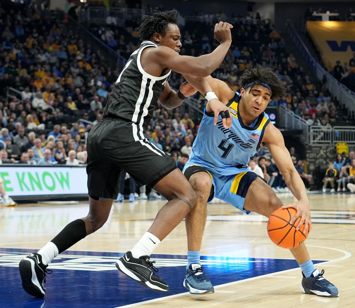 Marquette guard Stevie Mitchell (4) is guarded by Providence guard Jayden Pierre (1) during the first half of their game Wednesday, February 28, 2024 at Fiserv Forum in Milwaukee, Wisconsin.