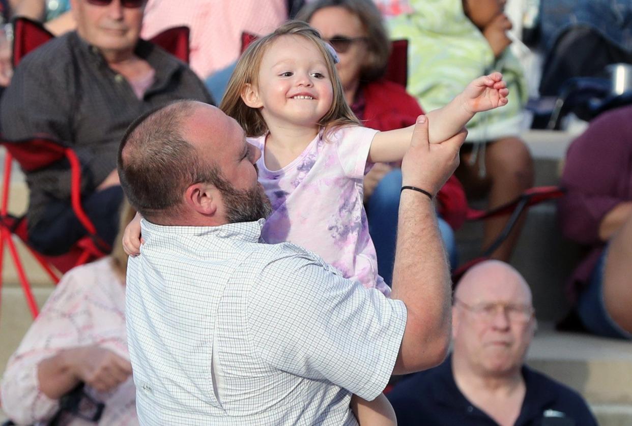 Paul Francis, of Hilliard, dances with his daughter, Evie Francis, 2, as The Simba Jordan Band performs during the Celebration at the Station on June 9 in Hilliard.