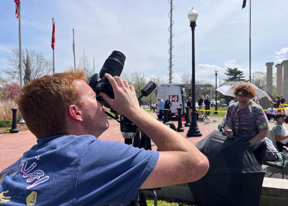 Mason McFerrin, of Murfreesboro, Tennessee, pears through his Nikon D7200 camera as he prepares to photograph the eclipse from Evansville’s riverfront.