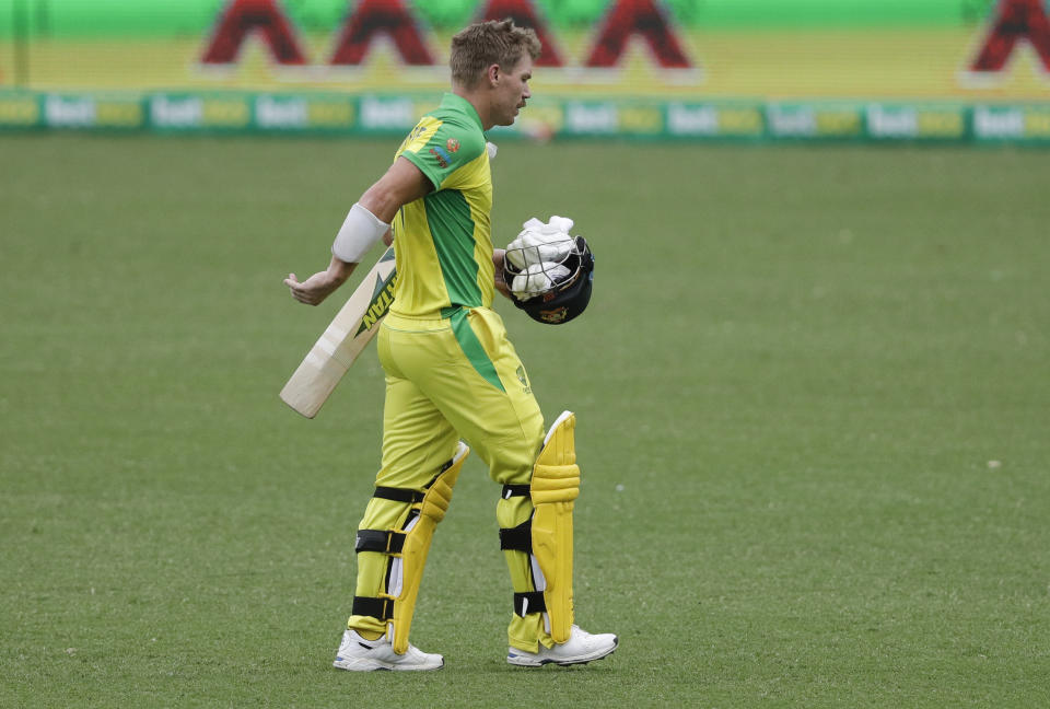 Australia's David Warner walks from the field after he was run out for 83 runs during the one day international cricket match between India and Australia at the Sydney Cricket Ground in Sydney, Australia, Sunday, Nov. 29, 2020. (AP Photo/Rick Rycroft)