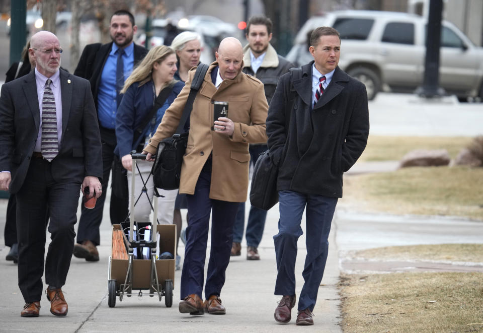 Michael J. Allen, front right, district attorney for Colorado's Fourth Judicial District, leads a contingent of lawyers into the El Paso County courthouse for a preliminary hearing for the alleged shooter in the Club Q mass shooting Wednesday, Feb. 22, 2023, in Colorado Springs, Colo. (AP Photo/David Zalubowski)