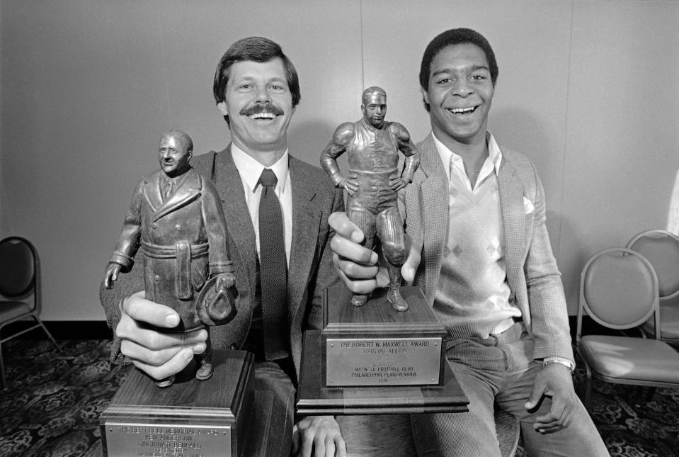 Cincinnati Bengals quarterback Ken Anderson, left, and USC running back Marcus Allen holds their Bert Bell Awards they received from the Maxwell Club, Feb. 11, 1982, in Philadelphia.  The Maxwell Club named Anderson the top pro football player and Allen the top player in college.