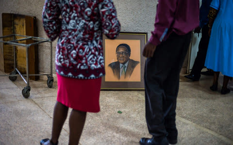 A portrait of former Zimbabwe president Robert Mugabe was removed from the hall during the 107th Zanu PF Central Committee meeting - Credit:  JEKESAI NJIKIZANA/AFP