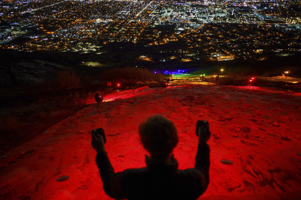 FILE - In this Thursday, March 4, 2021. file photo, a group of people, including many BYU students shine Pride colors on the Y on the mountain above BYU in Provo, Utah. Students at Brigham Young University illuminated the letter "Y" on a mountain overlooking the Provo campus on Thursday with rainbow colors in a display meant to send a message to the religious school. (Trent Nelson/The Salt Lake Tribune via AP, File)