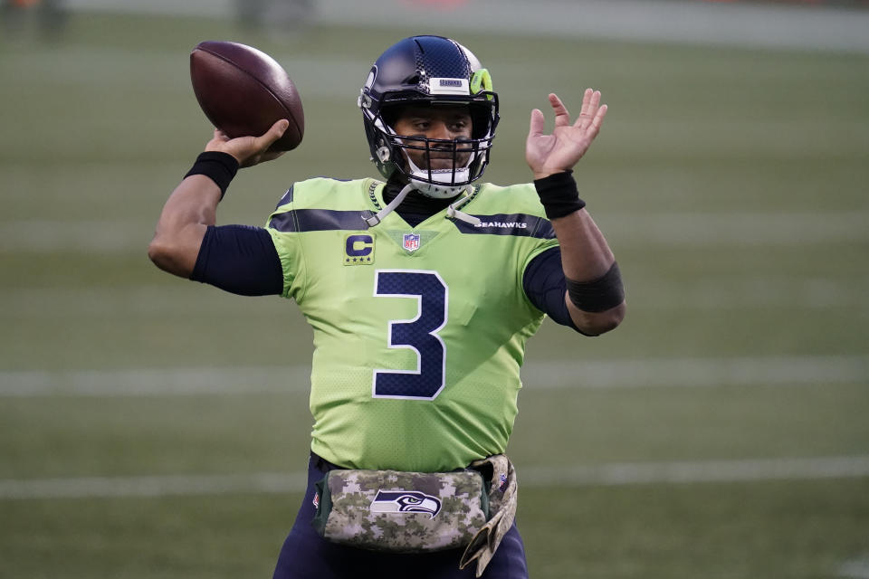 Seattle Seahawks quarterback Russell Wilson passes during warmups before an NFL football game against the Arizona Cardinals, Thursday, Nov. 19, 2020, in Seattle. Wilson's hand-warmer is part of the NFL's "Salute to Service" initiative. (AP Photo/Elaine Thompson)