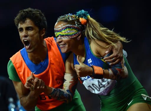 Brazil's Terezinha Guilhermina (right) and her guide Guilherme Soares de Santana celebrate after winning the women's 100m T11 final at the London 2012 Paralympic Games on September 5. Spurred on by Icelandic songstress Bjork, crowds at the London 2012 Paralympics are keeping a lid on their excitement for blind sports that need to be played in silence