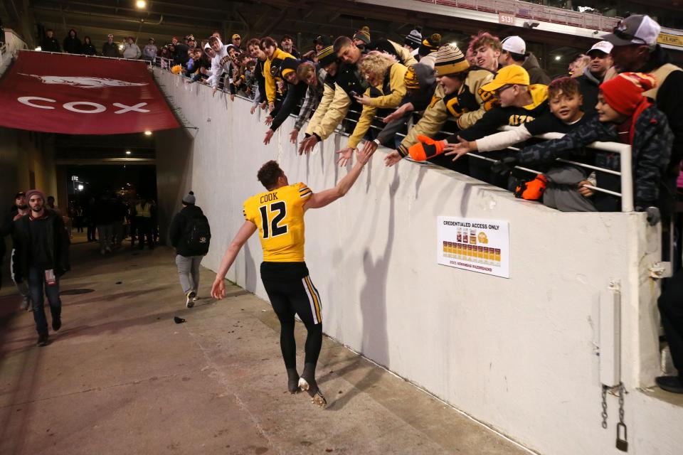 Nov 24, 2023; Fayetteville, Arkansas, USA; Missouri Tigers quarterback Brady Cook (12) celebrates with fans after the game against the Arkansas Razorbacks at Donald W. Reynolds Razorback Stadium. Missouri won 48-14. Mandatory Credit: Nelson Chenault-USA TODAY Sports