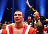 Tyson Fury celebrates after being declared the winner of the fight as Wladimir Klitschko looks dejected Reuters / Kai Pfaffenbach Livepic