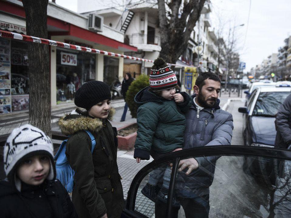 Residents of Kordelio district board a taxi after authorities ordered the evacuation of the area in order to defuse a 500-pound unexploded World War II bomb, in Thessaloniki, Greece: AP Photo/Giannis Papanikos